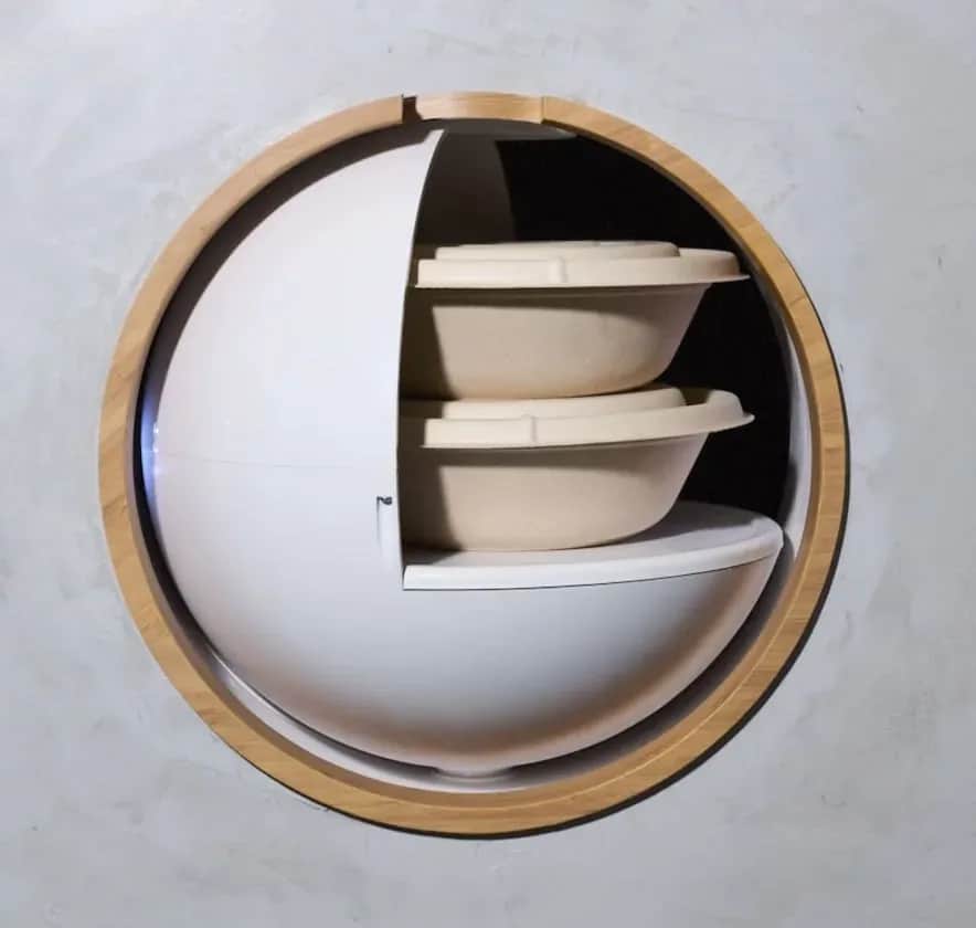 Bamboo Bowls pod mid-rotation, its white shell turning inside the wooden ring as the bowls come into view.